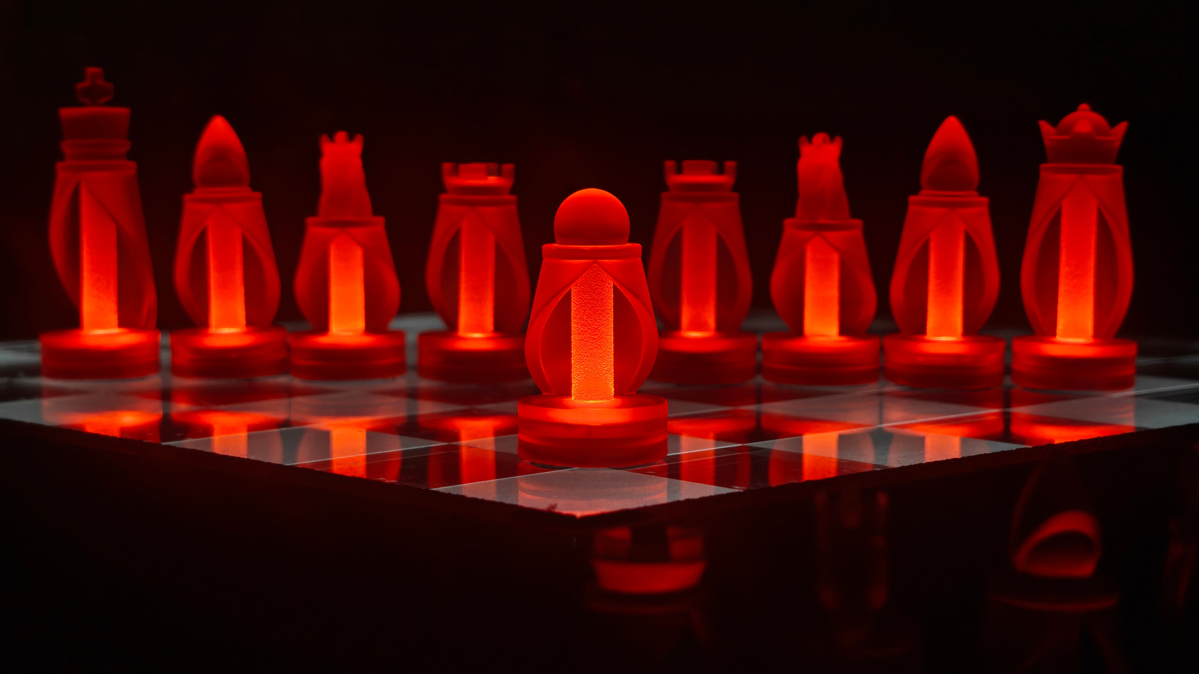 Chess set with glowing red pieces on a black chessboard